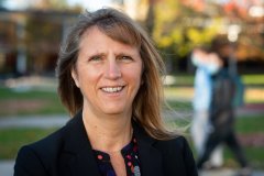 Polly Smith smiles at camera on campus at Utica College.