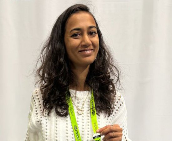 Dr. Rutal Mahajan stands in front of a white curtain